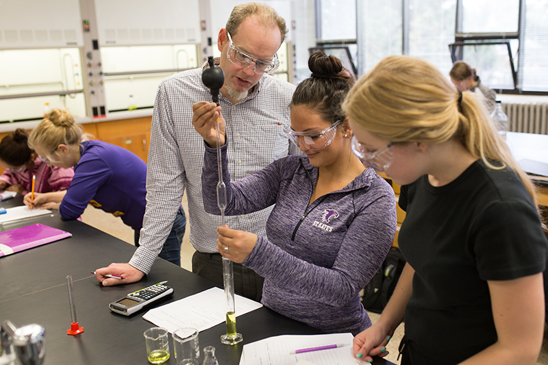 Students in chemistry lab working with teacher