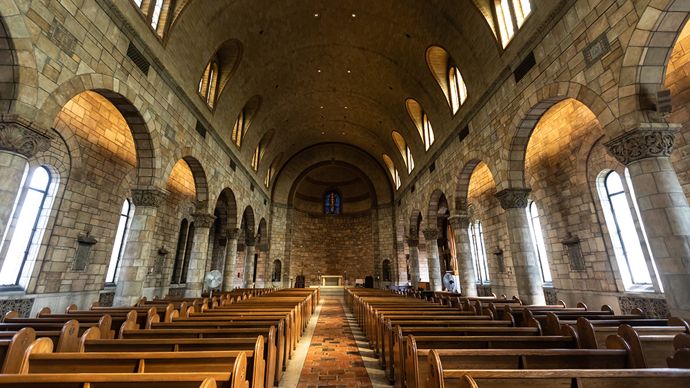 Our Lady of Victory Chapel interior view from the back looking up the center aisle to the altar