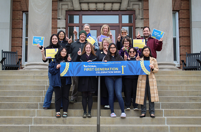Staff holding up sign celebrating international students