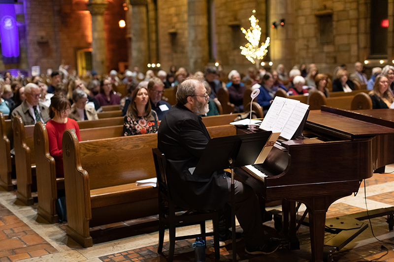 Piano player performing at concert in chapel