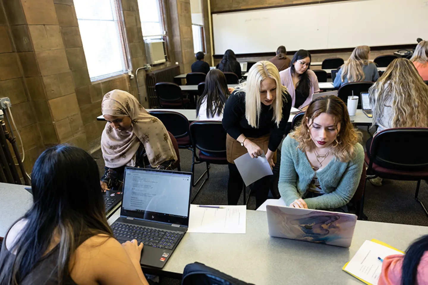 Students working in classroom on laptops
